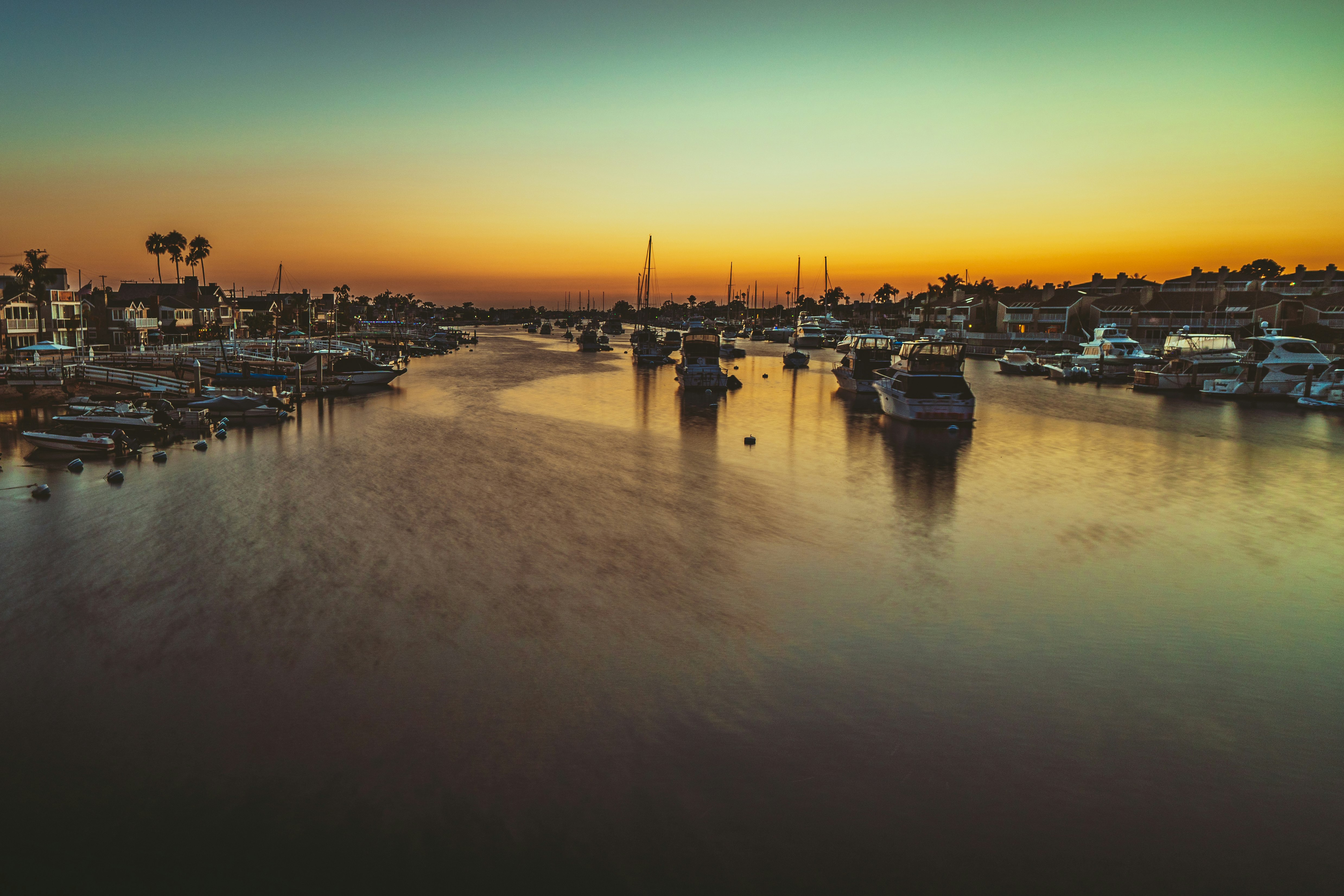 boats on dock during sunset